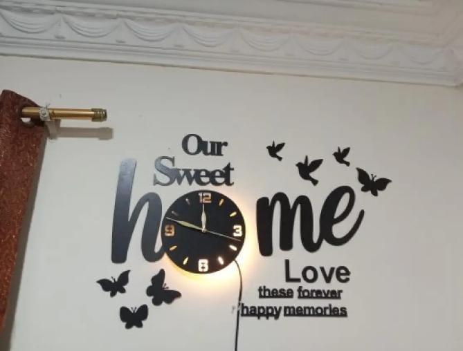 Our Sweet Home black wall clock and bird silhouettes on a white wall