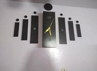 Black slot-style wall clock mounted on a light wall
