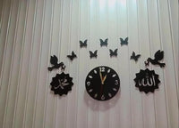 Close-up of black Islamic wall clock with Arabic calligraphy and bird motifs