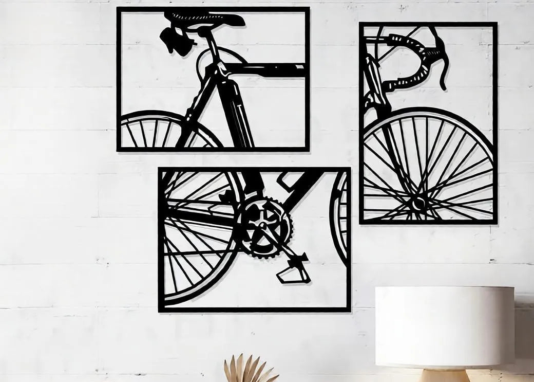 Three black bicycle wall art panels displayed on a white wall