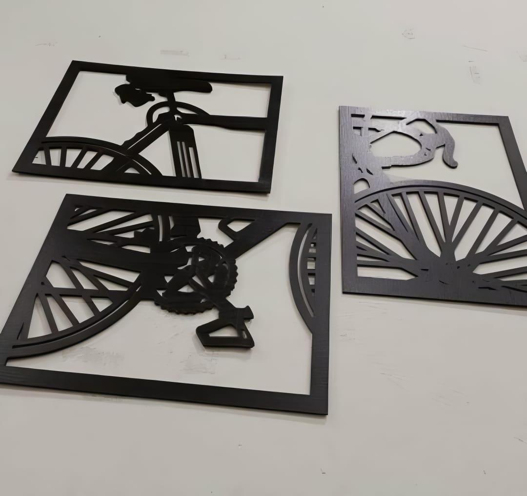 Three bicycle wall art pieces displayed above a console
