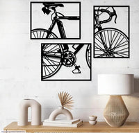 Black bicycle wall art arranged as three panels in a room setting
