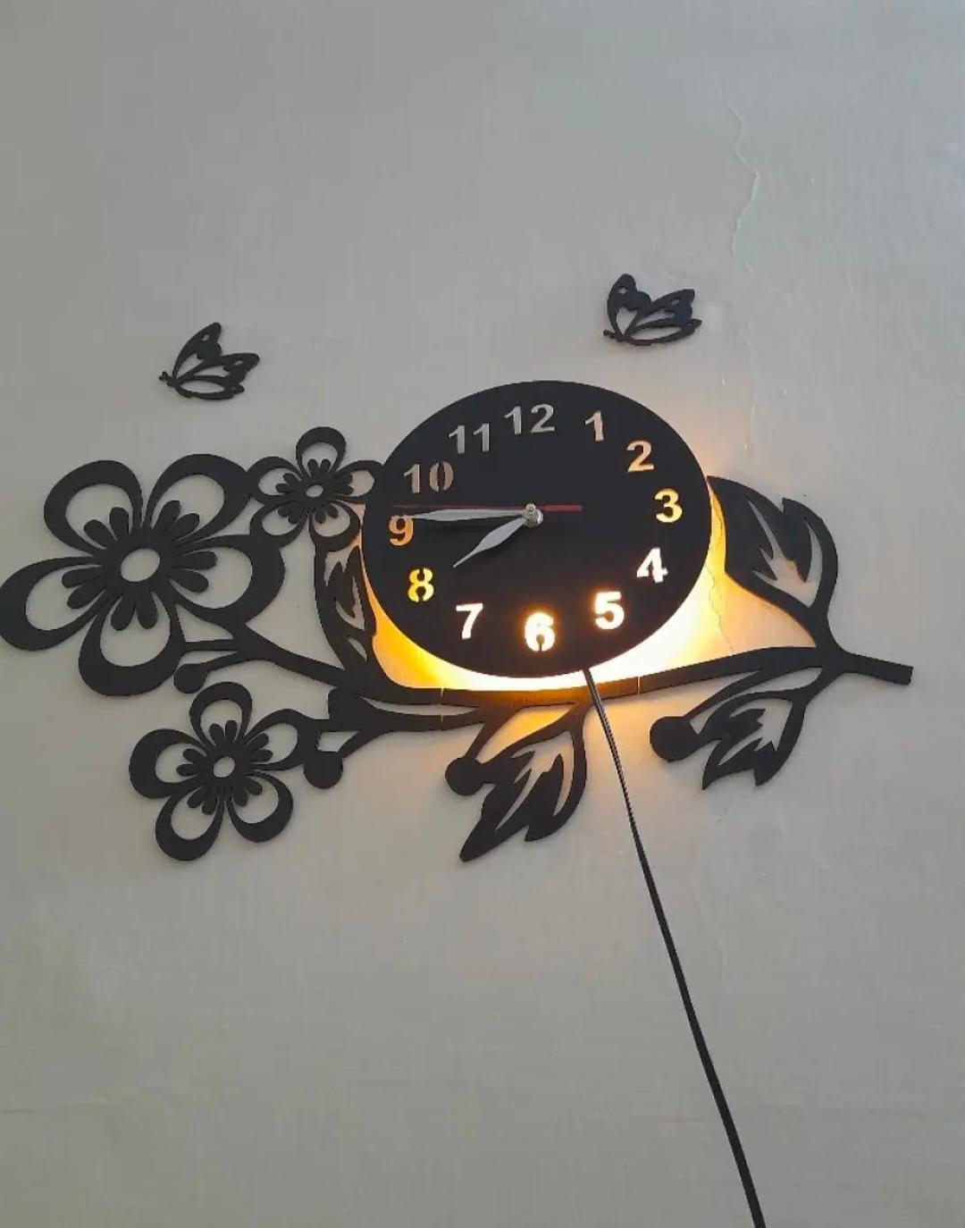 Black floral wall clock mounted above doorway