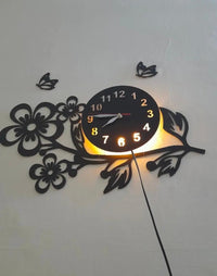 Black floral wall clock mounted above doorway