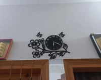 Warmly illuminated black flower wooden wall clock on white wall