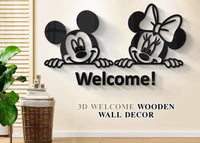 Black Welcome wall art with two cartoon mouse characters on a wall