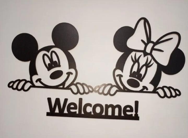 Two cartoon mouse characters peeking above Welcome lettering