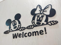 Close-up of black wooden mouse-character Welcome wall decor