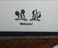 Black cartoon mouse Welcome wall art installed on a light wall