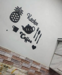 Black wooden kitchen wall decor pieces laid out on a light surface