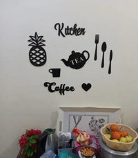 Kitchen-themed black wall art arranged above a counter