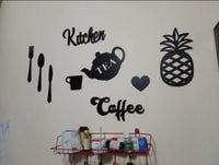Black pineapple and Kitchen Coffee decorative wall art on a wall