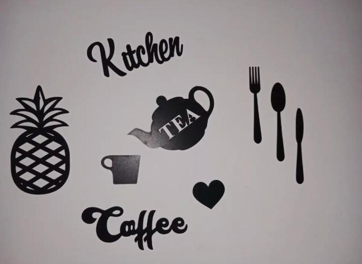 Kitchen wall art pieces displayed over a shelf
