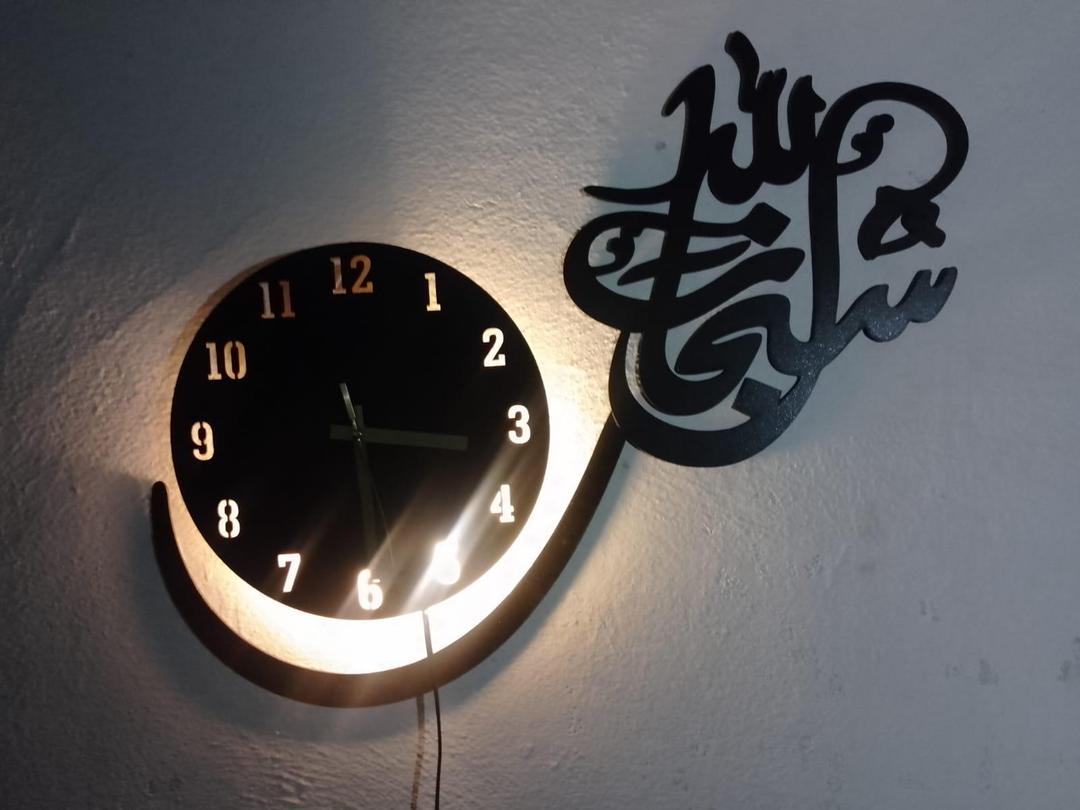 Subhan Allah Arabic calligraphy clock glowing in low light