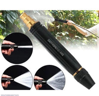 Adjustable water pressure nozzle spraying plants outdoors